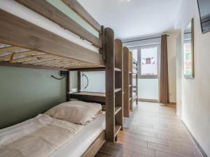 a room with three bunk beds and a hallway at Emma Top 1 XL in Dienten am Hochkönig