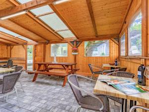 a living room with tables and chairs and windows at Grieswirt L in Itter