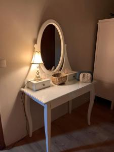 a table with a lamp and a mirror on it at Homestay Snæfellsnes in Stykkishólmur