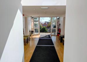 an open hallway with a black rug in a house at Oscar Lodge in Northampton
