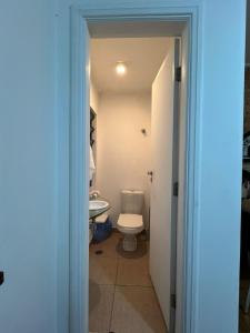 a bathroom with a toilet and a sink at Refugio Madalena Hostel in São Paulo +24 photos