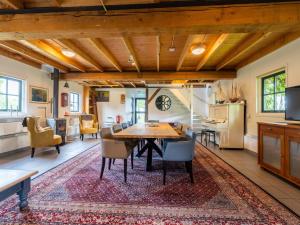 a kitchen and dining room with a table and chairs at De Schuur in Kaag