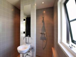 a bathroom with a toilet and a sink at De Schuur in Kaag