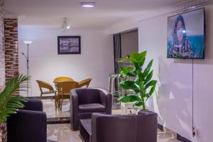 a waiting room with chairs and a table at Beulah House Lounge in Ibadan