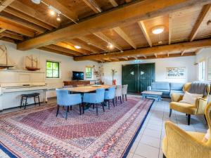 a living room with a table and chairs at De Schuur in Kaag +53 photos