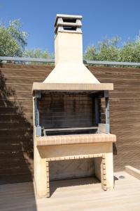 a brick oven on top of a patio at Villa Helona in Keri