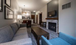 a living room with a couch and a fireplace at Blue Mountain Resort Village Suites in Blue Mountains