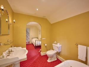 a bathroom with a white toilet and a sink at Erve Het Klaashuis in Deurningen +64 photos