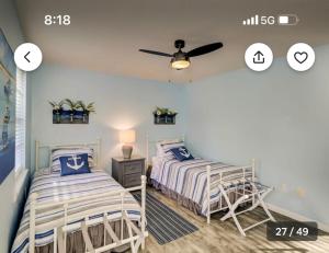 a bedroom with two beds and a ceiling fan at Pet Friendly | Pool | Tennis | Walk to Shops in Hilton Head Island +46 photos