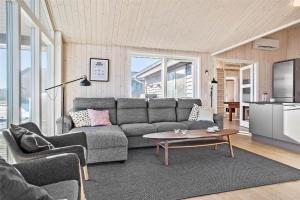 a living room with a couch and a table at 30434-Odder-Strandvaenget-10 in Odder