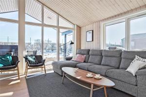 a living room with a couch and a table at 30434-Odder-Strandvaenget-10 in Odder