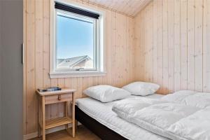 two beds in a room with a window at 30434-Odder-Strandvaenget-10 in Odder