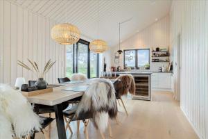 a dining room with a table and some chairs at 30458-Odder-Strandvaenget-44 in Odder