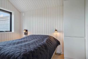 a bedroom with a bed and a window at 30458-Odder-Strandvaenget-44 in Odder