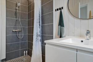a bathroom with a shower with a sink and a mirror at 30458-Odder-Strandvaenget-44 in Odder +22 photos