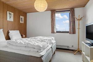 a bedroom with a large bed and a window at 30486-Odder-Kirkeager-5 in Odder