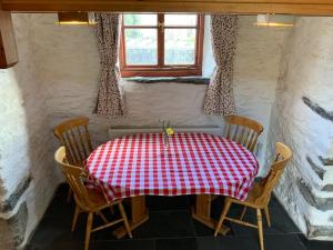 a table with a red and white checkered table cloth at Tithe Barn 1 - Abercelyn Cottages - Llanycil - Bala - Gwynedd - LL23 7YF - UK in Llanycil +7 photos