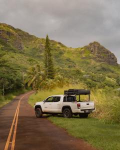 a white truck parked on the side of a road at Escape It All Rooftop Glamper fully equipped Tacoma in Anahola
