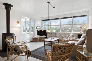 a living room with a couch and a fireplace at 30320-Odder-Violvej-15 in Odder