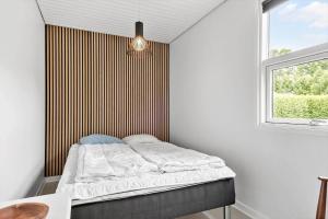 a bed in a room with a window at 30320-Odder-Violvej-15 in Odder