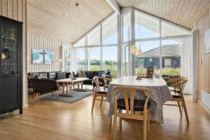 a living room with a couch and a table and chairs at 30460-Odder-Strandvaenget-16 in Odder