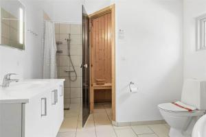 a white bathroom with a toilet and a shower at 30460-Odder-Strandvaenget-16 in Odder +27 photos
