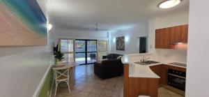 a kitchen and living room with a couch and a table at Waterfront Terraces in Cairns +13 photos