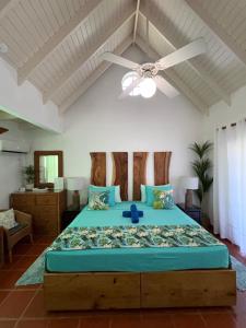 a bedroom with a large bed with a ceiling fan at Reefside Villa in Crown Point +60 photos