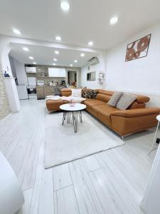 a living room with a couch and a table at Alia house with garden in Piešťany in Piešťany