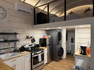 a kitchen with a stove and a refrigerator at Backyard Tiny House in the Woods in Tolland