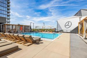 a swimming pool on the roof of a building with lounge chairs at Hotel Phoenix Atlanta in Atlanta
