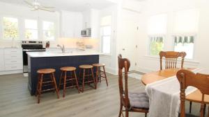 a kitchen with a counter and a table and chairs at The Perry Street Hideaway in Cape May