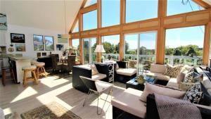 a living room with a lot of furniture and windows at 3 Bedroomgorgeous Sunset Views!! in West Cape May