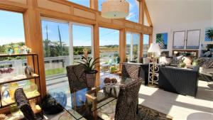 a living room with large windows and a room with chairs at 3 Bedroomgorgeous Sunset Views!! in West Cape May