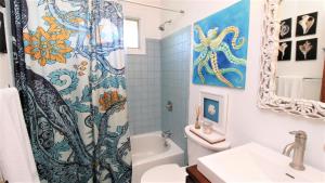 a bathroom with a shower curtain and a toilet at 3 Bedroomgorgeous Sunset Views!! in West Cape May +23 photos