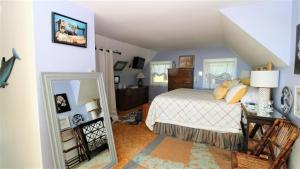 a bedroom with a bed and a mirror at 3 Bedroomgorgeous Sunset Views!! in West Cape May