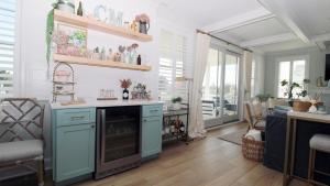 a kitchen with blue cabinets and a living room at Seashell Sanctuary in Cape May