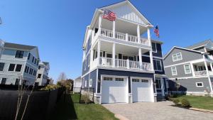 a large white house with two garages at Seashell Sanctuary in Cape May