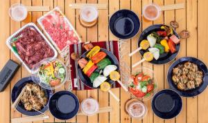a wooden table with plates of food on it at ReSchool Nasu Glamp in Nasu +18 photos