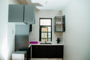 a kitchen with a sink and a window at Ham Homes in Kampala