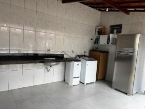 a kitchen with two refrigerators and other appliances at Estrela de Euclides in Euclides da Cunha +7 photos