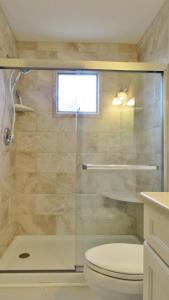 a bathroom with a glass shower with a toilet at Marilyns Cottage in Cape May +14 photos