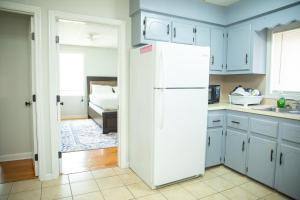 a kitchen with a white refrigerator and a bedroom at Private Room #3 Fall River MA in Fall River