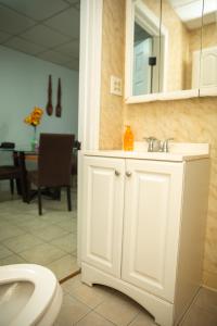 a bathroom with a white sink and a toilet at Private Room #3 Fall River MA in Fall River