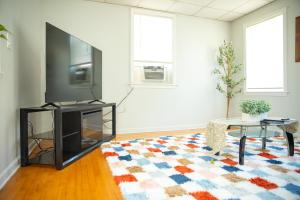 a living room with a tv and a table and a rug at Private Room #3 Fall River MA in Fall River +5 photos