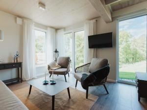 a living room with two chairs and a tv at Urlaub genießen in Sagard auf Rügen in Sagard