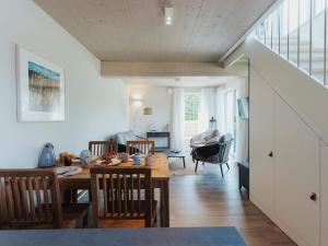 a dining room and living room with a table and chairs at Urlaub genießen in Sagard auf Rügen in Sagard