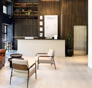 a lobby with chairs and a counter in a store at Laureles Selection Suites in Medellín