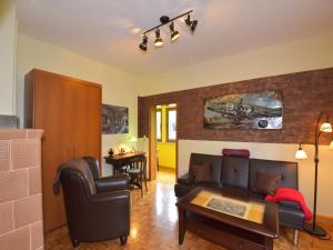 a living room with a couch and a table at Ferienwohnung im Erholungsort in Kurort Steinbach-Hallenberg
