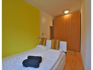 a white bed in a room with a green wall at Ferienwohnung im Erholungsort Suhl in Suhl